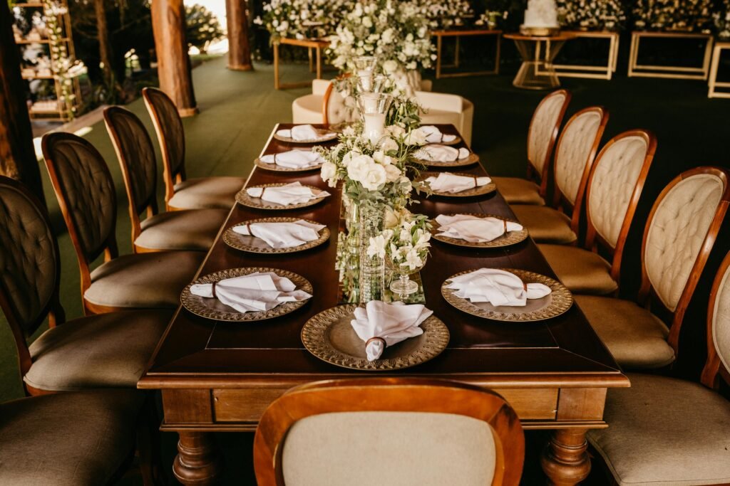 pexels-photo-12876506-12876506 Luxurious dining table setup with ornate chairs and floral centerpiece, perfect for a formal gathering.